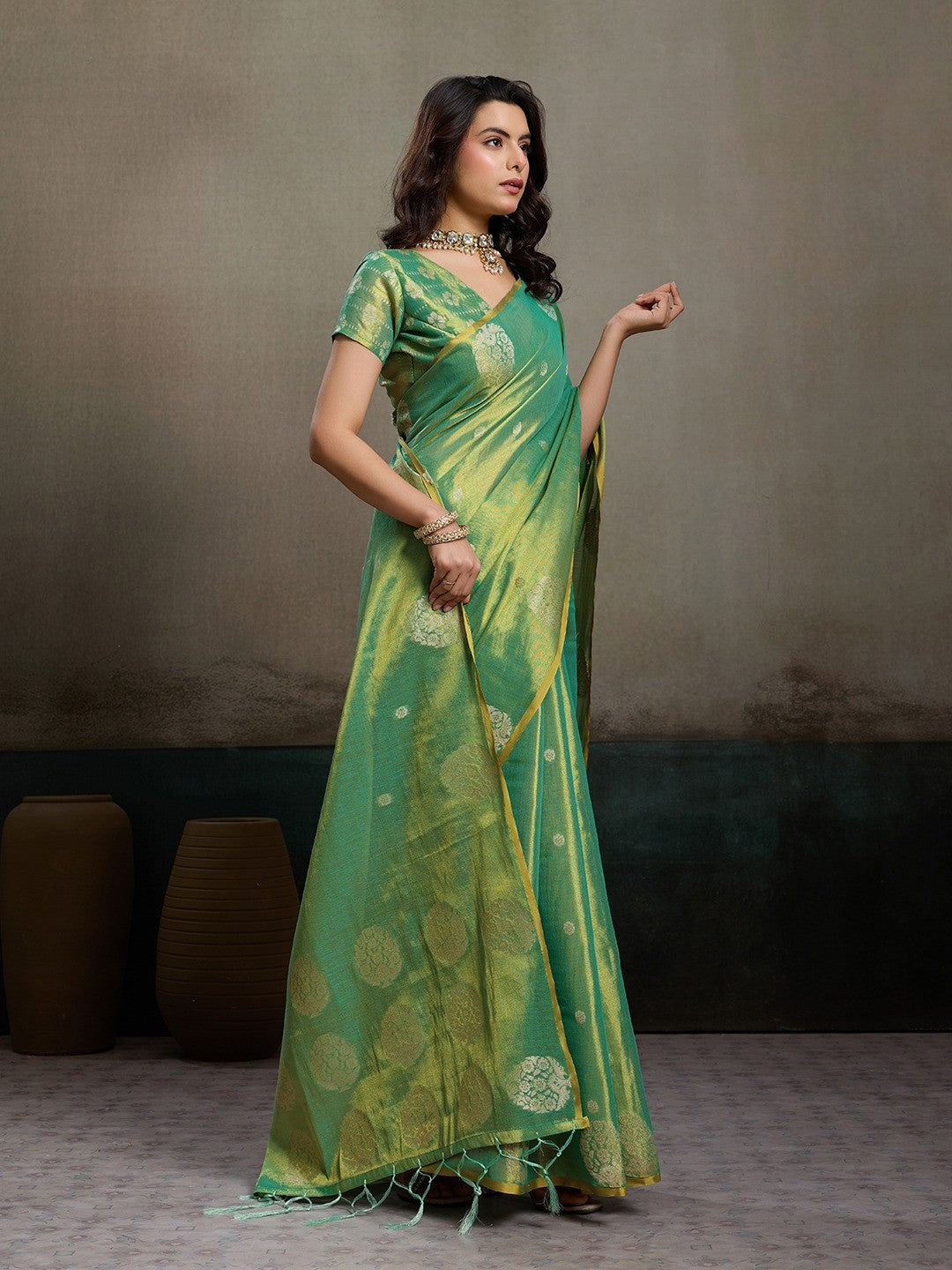 Stylish Green Tissue Saree with Fine Woven Floral Patterns and Glossy Finish