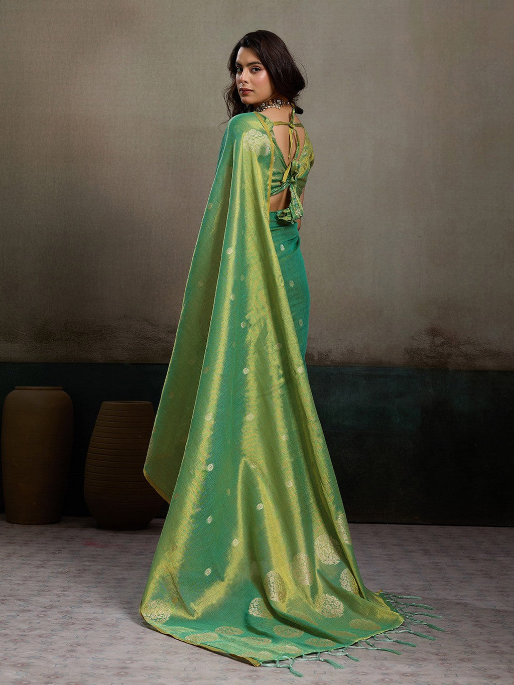 Stylish Green Tissue Saree with Fine Woven Floral Patterns and Glossy Finish