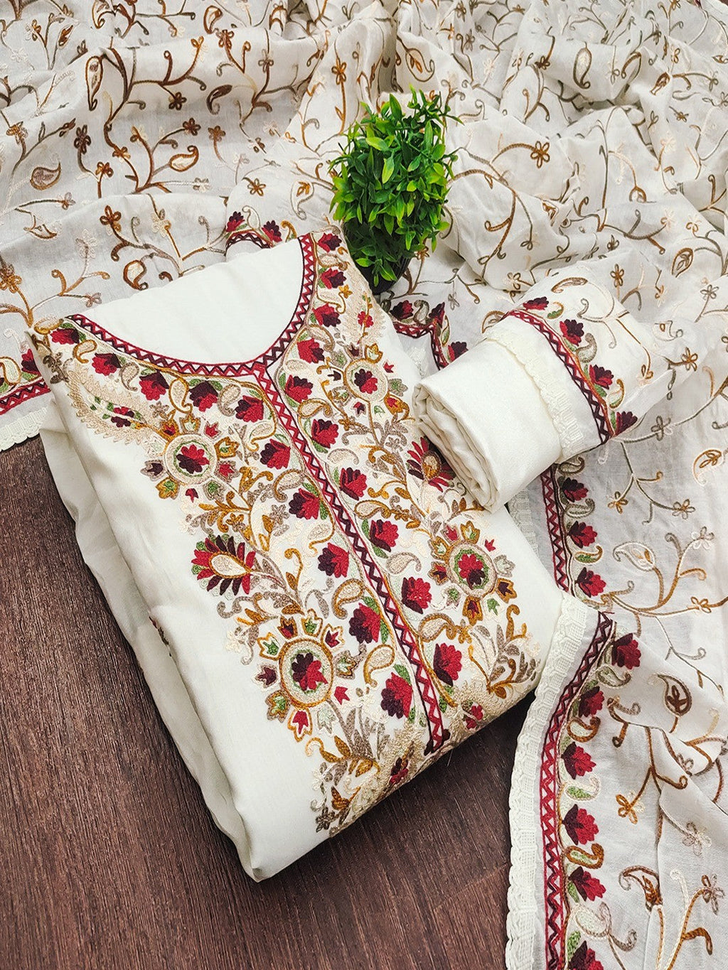 Ethnic Offwhite Roman Art Silk Dress Material Highlighted With Floral & Paisley Thread Embroidery