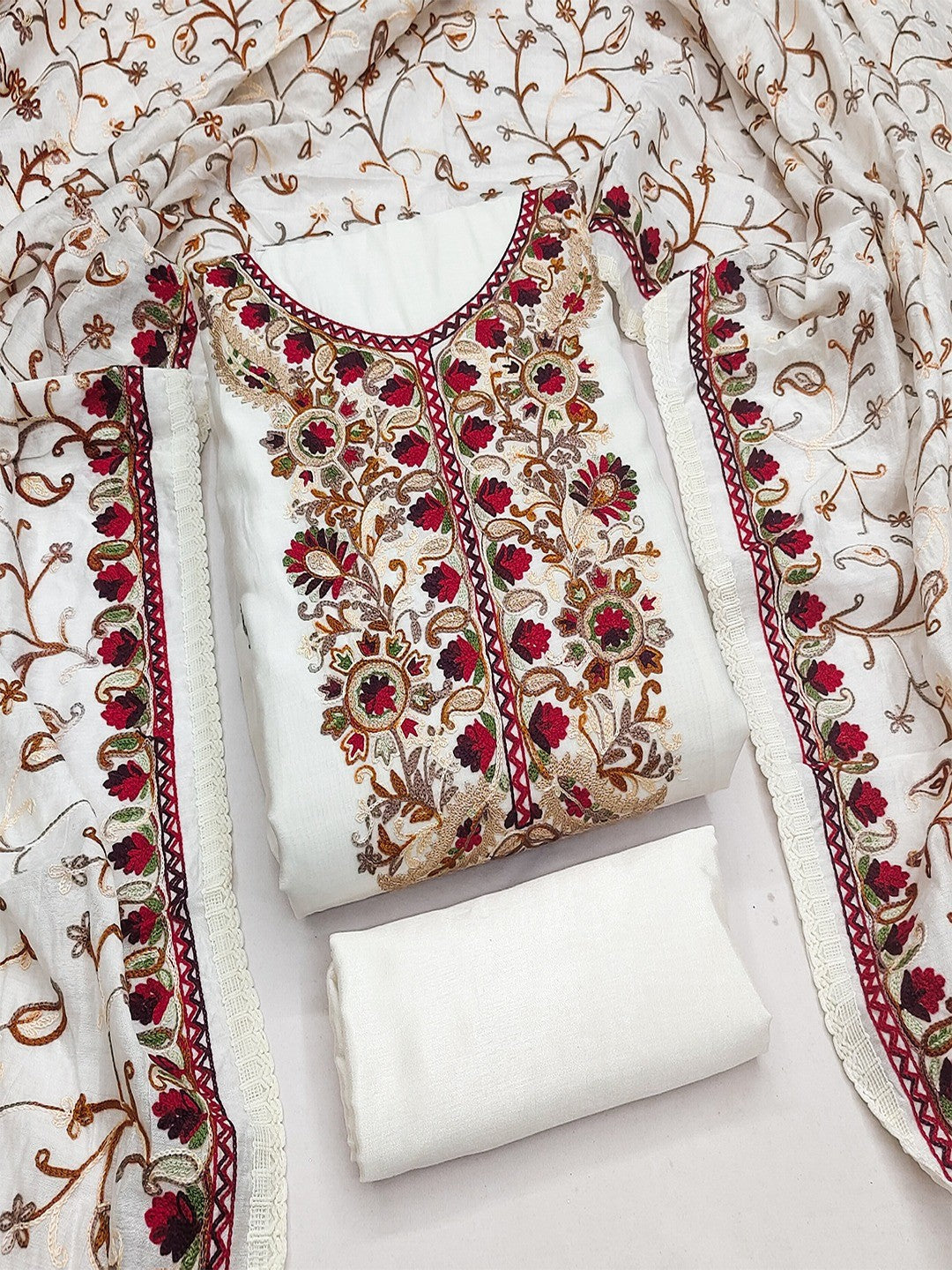 Ethnic Offwhite Roman Art Silk Dress Material Highlighted With Floral & Paisley Thread Embroidery