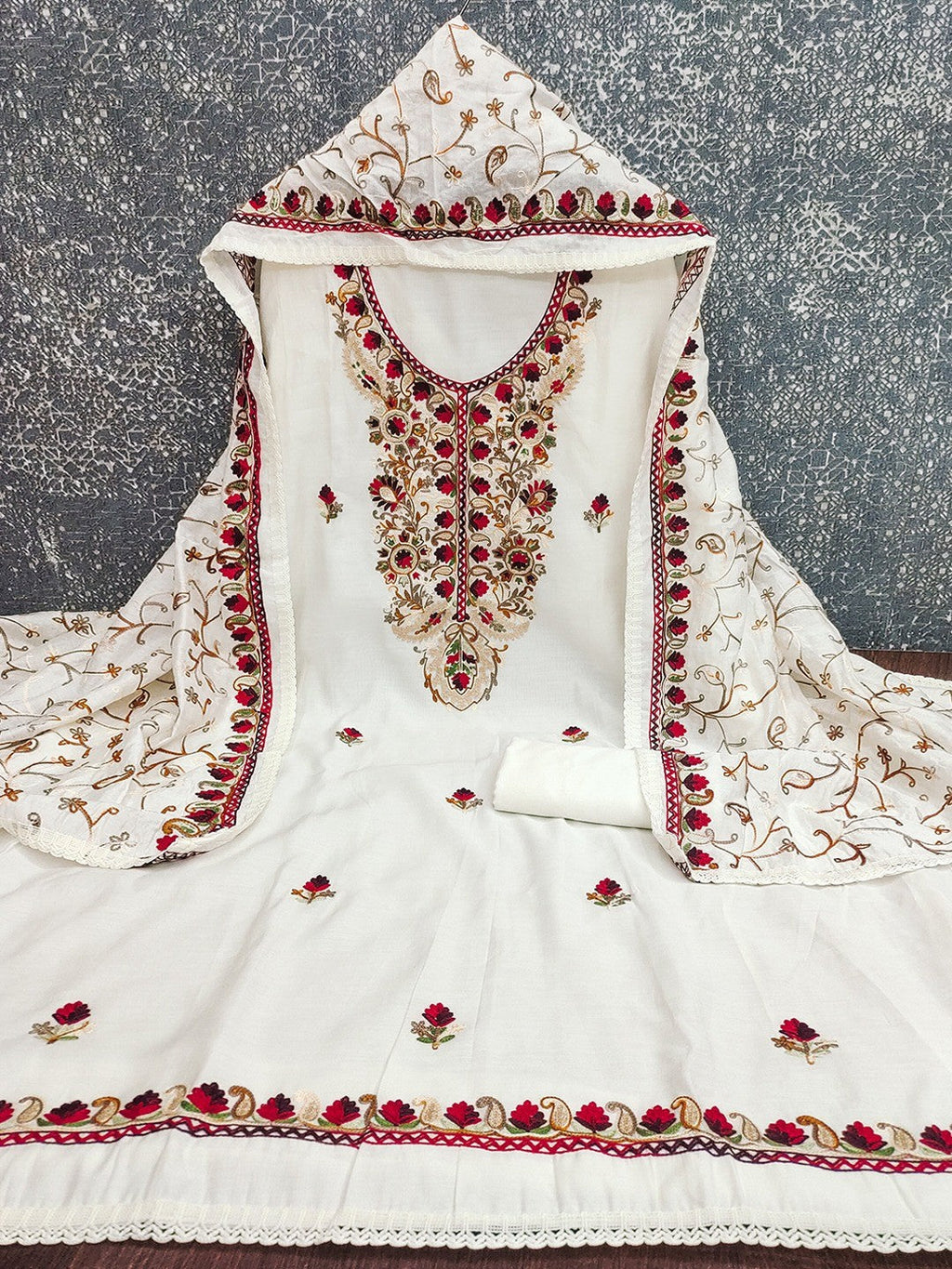 Ethnic Offwhite Roman Art Silk Dress Material Highlighted With Floral & Paisley Thread Embroidery