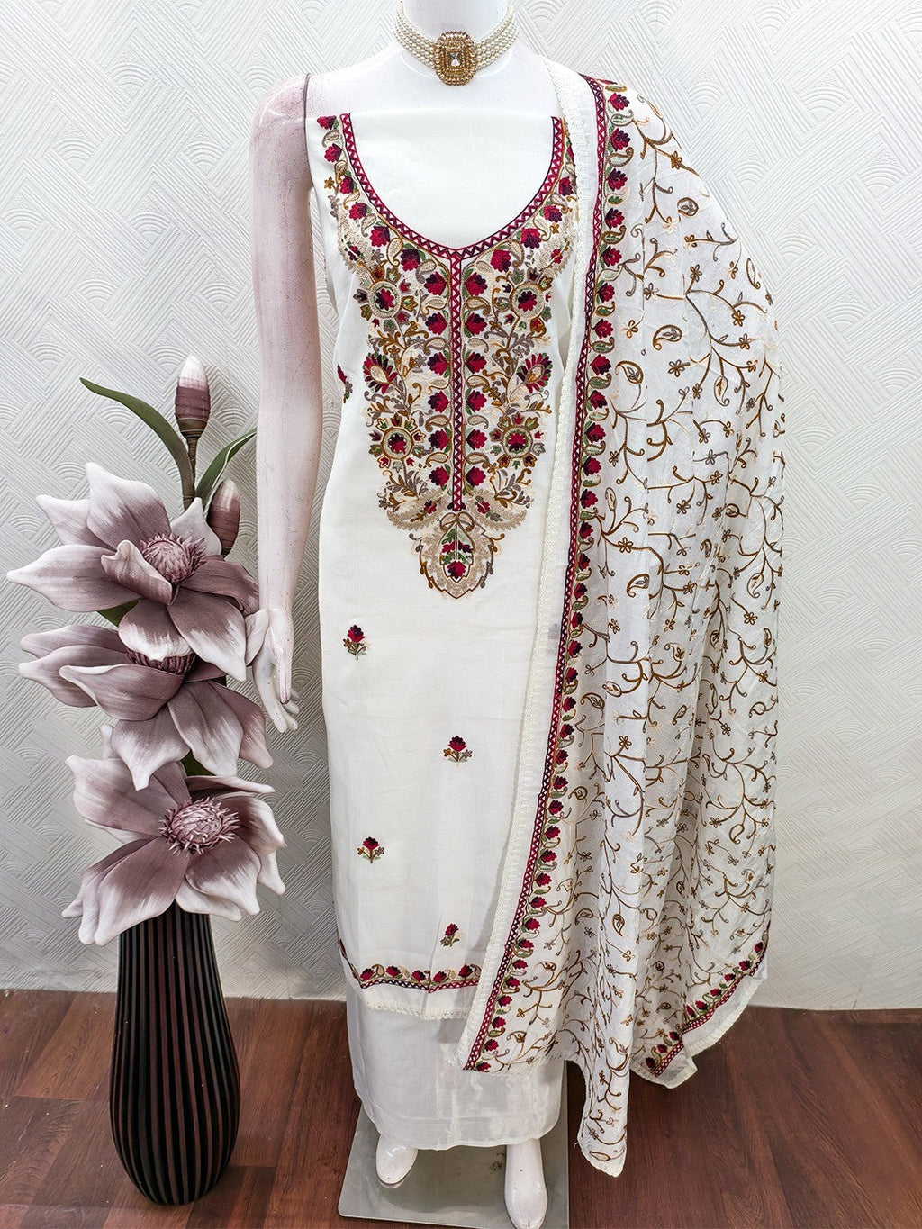 Ethnic Offwhite Roman Art Silk Dress Material Highlighted With Floral & Paisley Thread Embroidery