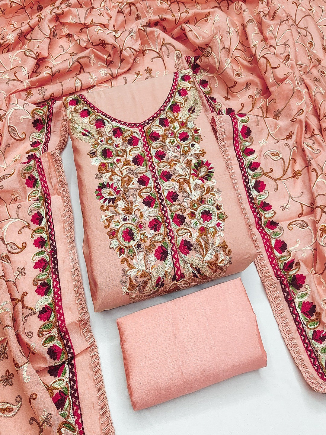 Ethnic Peach Roman Art Silk Dress Material Highlighted With Floral & Paisley Thread Embroidery