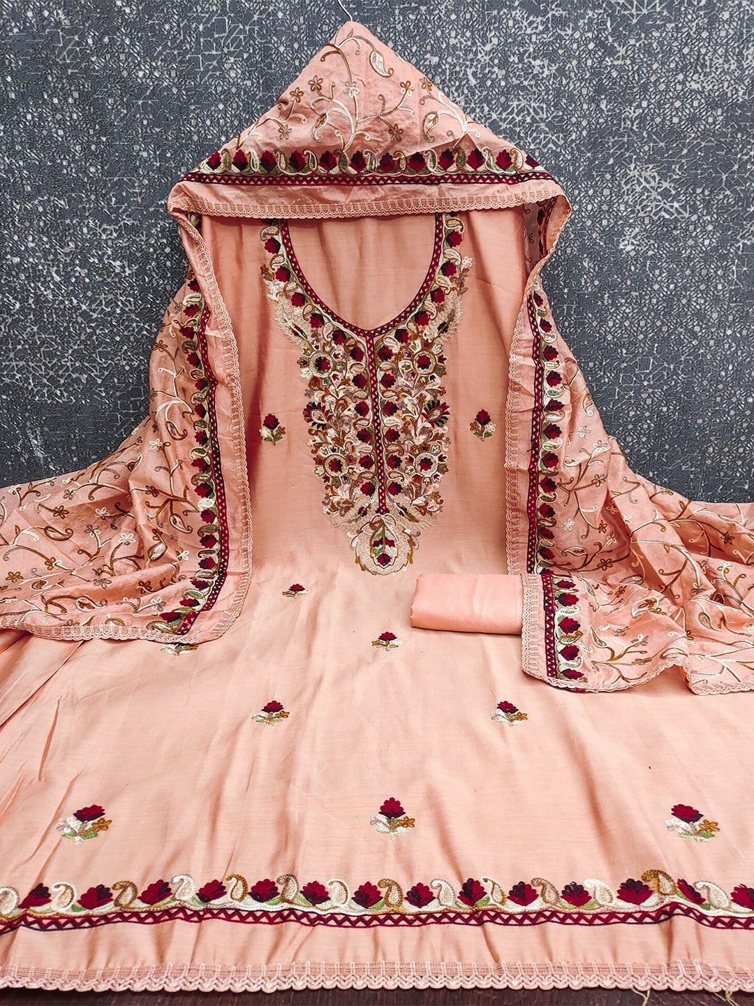 Ethnic Peach Roman Art Silk Dress Material Highlighted With Floral & Paisley Thread Embroidery