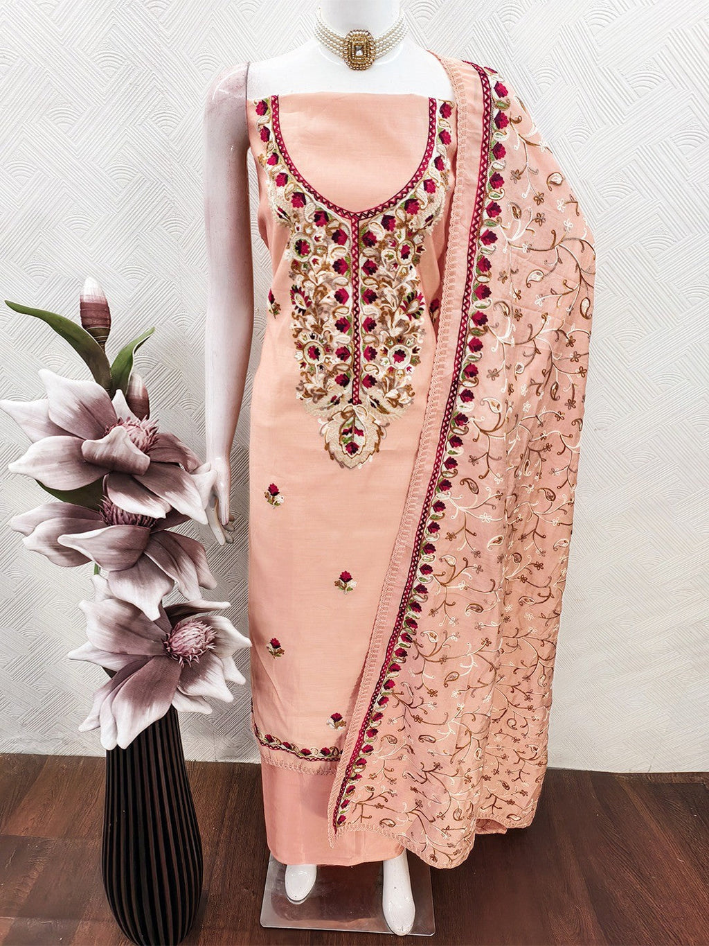 Ethnic Peach Roman Art Silk Dress Material Highlighted With Floral & Paisley Thread Embroidery