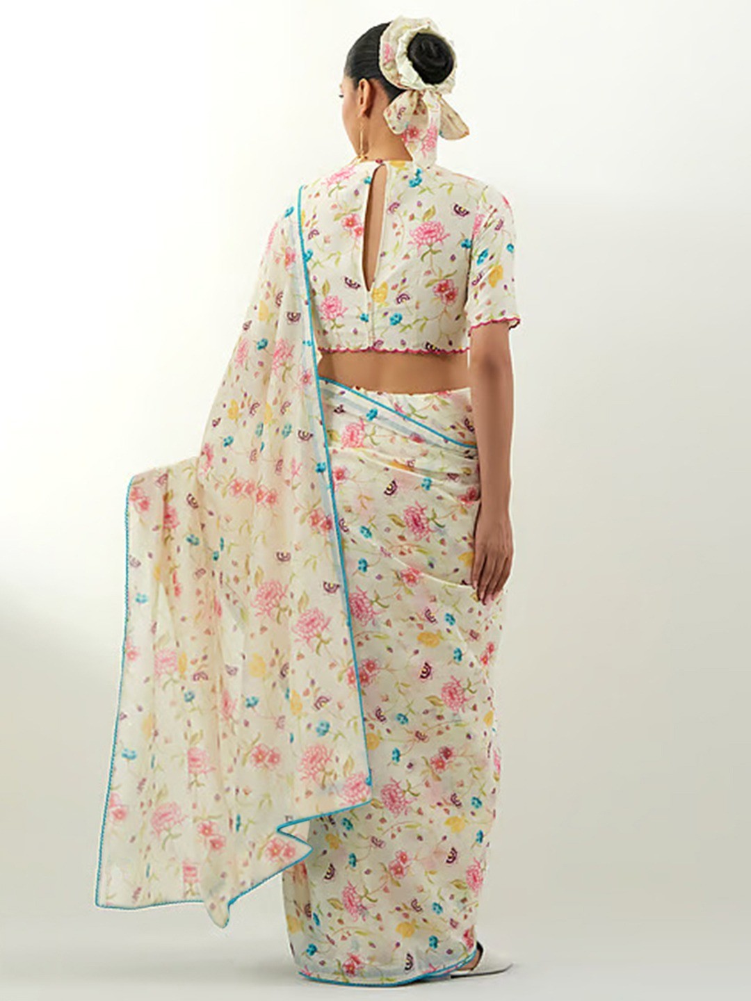 Stylish Cream Floral Print Georgette Saree Highlighted With Lace Border Finish