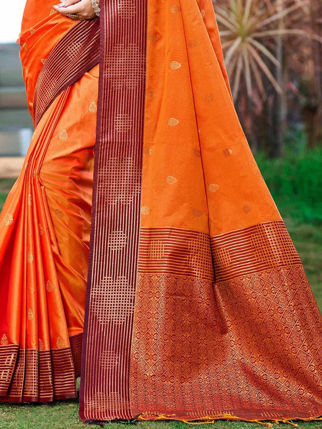 Graceful Orange Zari Woven Silk Blend Saree With Floral Motif Detailing & Elegant Tassels Pallu
