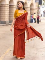 Charming Rust Solid Mulmul Cotton Saree Highlighted By Zari Weaving Border & Tassel Pallu