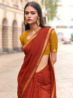 Charming Rust Solid Mulmul Cotton Saree Highlighted By Zari Weaving Border & Tassel Pallu