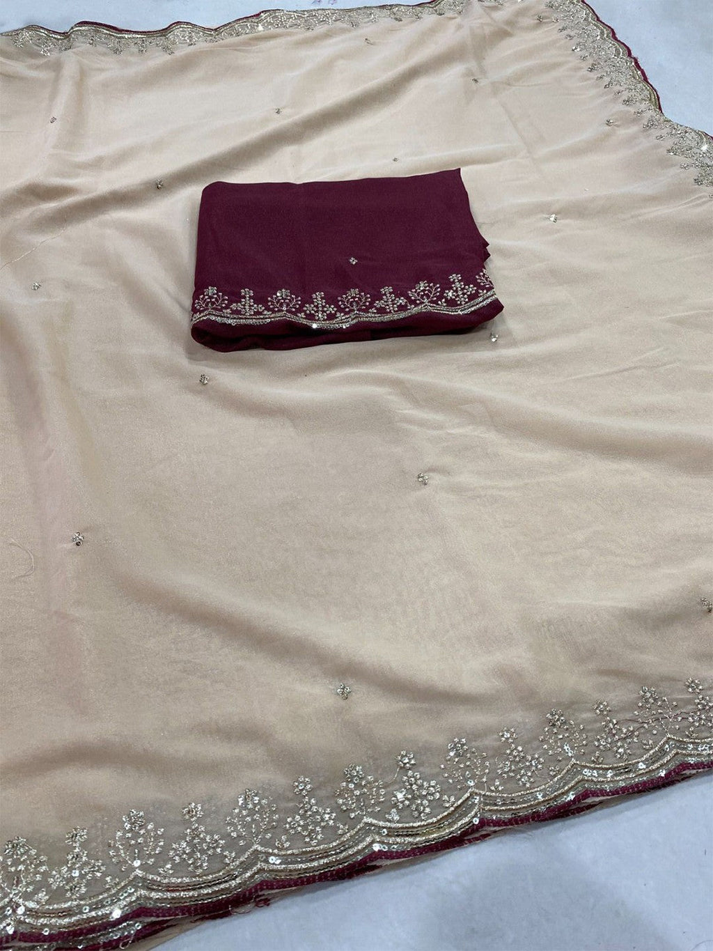 Luxurious Cream Georgette Saree with Sequins Butti and Scalloped Border